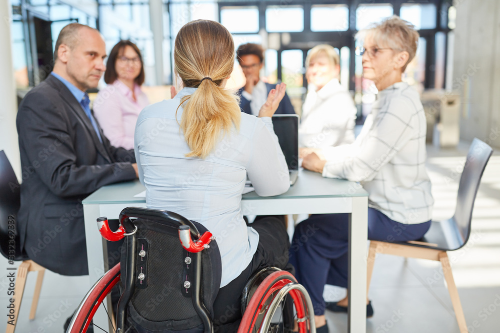 © Robert Kneschke - Business woman in a wheelchair in a project meeting