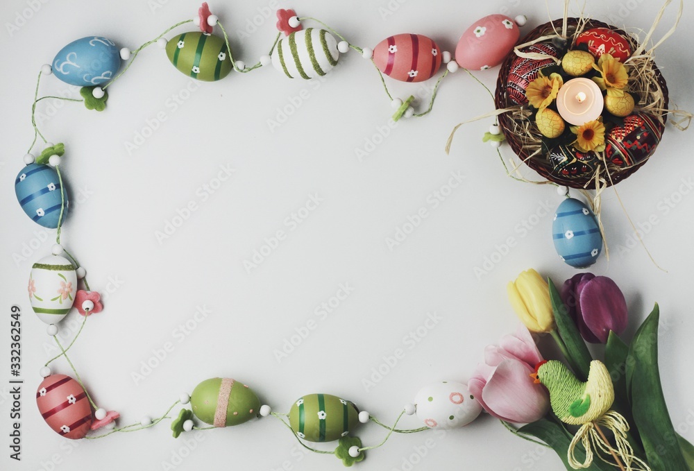Beautiful Eastern style flat lay with traditional painted eggs and tulips