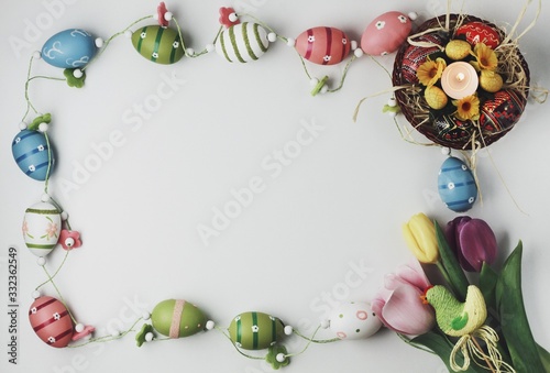 Obraz na płótnie Beautiful Eastern style flat lay with traditional painted eggs and tulips w salonie