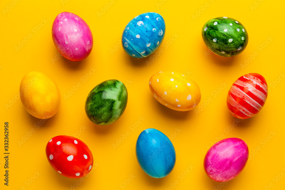 Bright easter eggs on yellow background. Retro colorful spring decoration.
