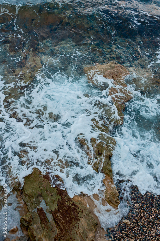 waves of the Mediterranean rush to the hot rocky beach on the Greek island of Crete waves of the Mediterranean rush to the hot rocky beach on the Greek island of Crete