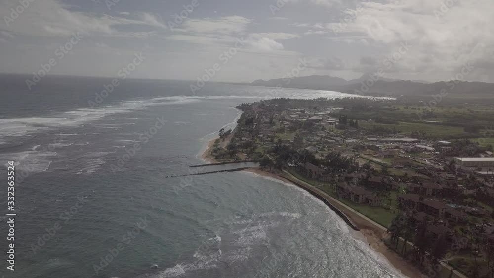 An ungraded drone shot of the Koloa coast in Kauai, Hawaii. Waves lapping up against the shore. An ungraded drone shot of the Koloa coast in Kauai, Hawaii. Waves lapping up against the shore.