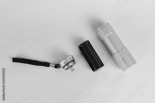 Torch light with bulb in parts at the white background