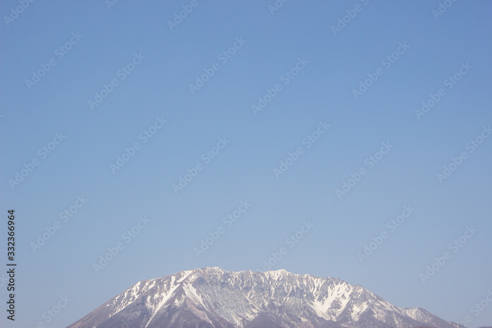 blue sky and snow covered mountains in winter