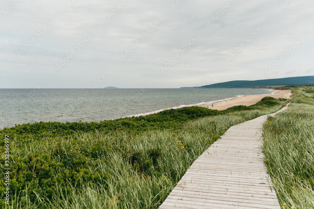 Fototapeta premium Wood boardwalk at Inverness Beach on the west coast of Cape Breton Island, Nova Scotia, Canada