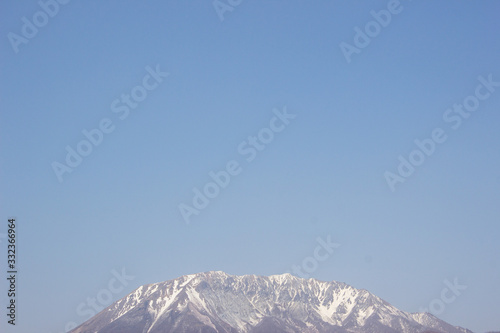 blue sky and snow covered mountains in winter