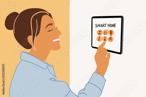 Woman controlling home with a digital touch screen panel installed on the wall indoors. Concept of a smart home. Colorful vector illustration in flat cartoon style