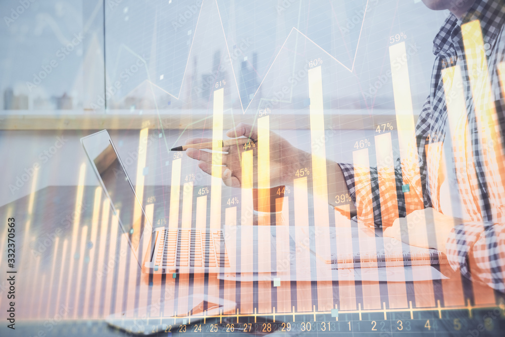 Double exposure of stock market chart with man working on computer on background. Concept of financial analysis. Double exposure of stock market chart with man working on computer on background. Concept of financial analysis.