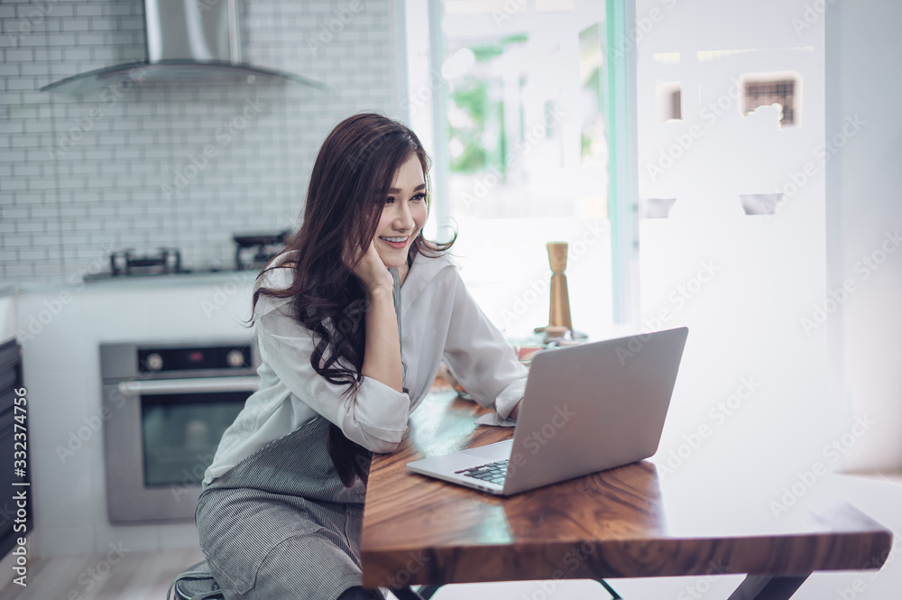 Portrait of beautiful young latin woman talking over the phone while cooking in kitchen Portrait of beautiful young latin woman talking over the phone while cooking in kitchen
