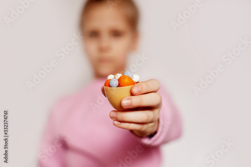 The girl is holding small chocolate eggs lying in one large egg. Concept of the Easter holiday