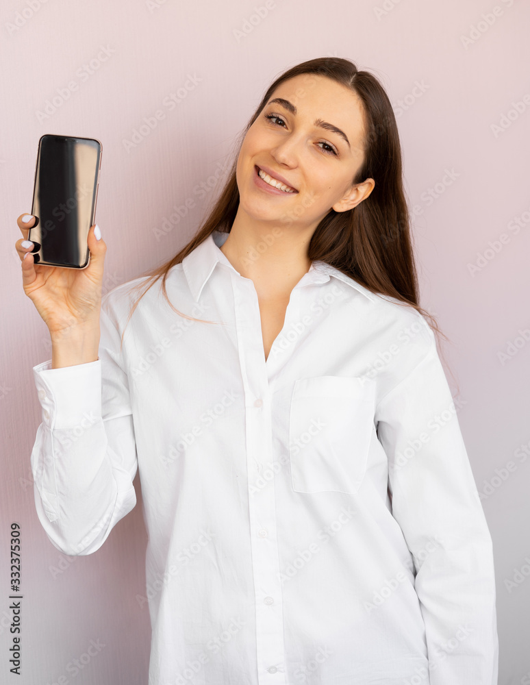 girl holds a mobile smartphone. Shows phone screen in camera girl holds a mobile smartphone. Shows phone screen in camera