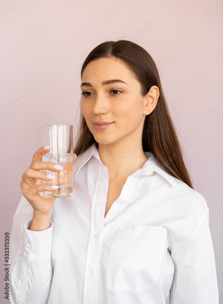 girl drinks water from a glass. body water balance, proper healthy nutrition girl drinks water from a glass. body water balance, proper healthy nutrition