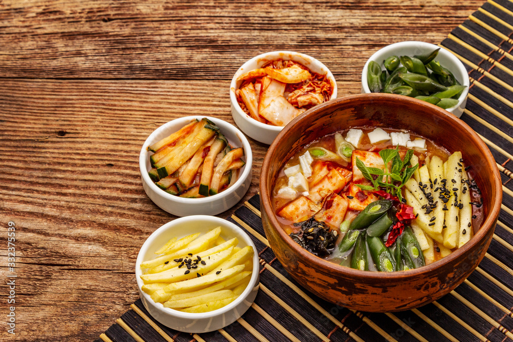 Traditional Korean spicy soup with kimchi, tofu, vegetables. Hot dish for healthy meal Traditional Korean spicy soup with kimchi, tofu, vegetables. Hot dish for healthy meal