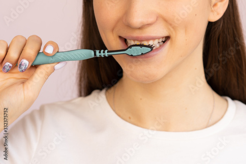 girl with a toothbrush and a beautiful smile, protection and brushing