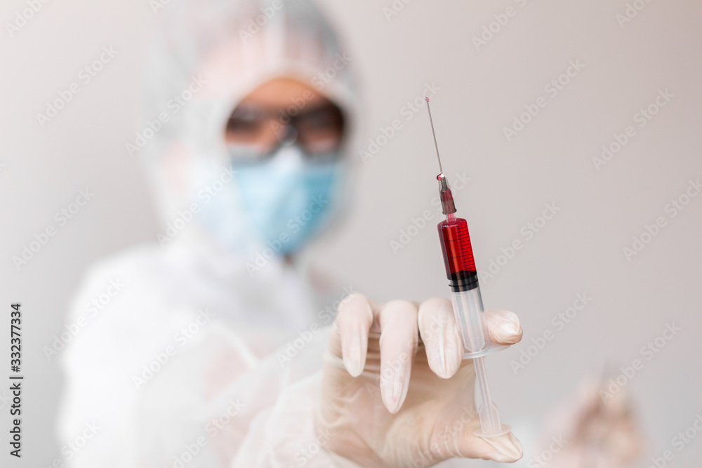 A medic holds a test tube with blood for the analysis of 2019 nKoV. Coronavirus blood test concept. Test for COVID-19 in the hands of a doctor A medic holds a test tube with blood for the analysis of 2019 nKoV. Coronavirus blood test concept. Test for COVID-19 in the hands of a doctor