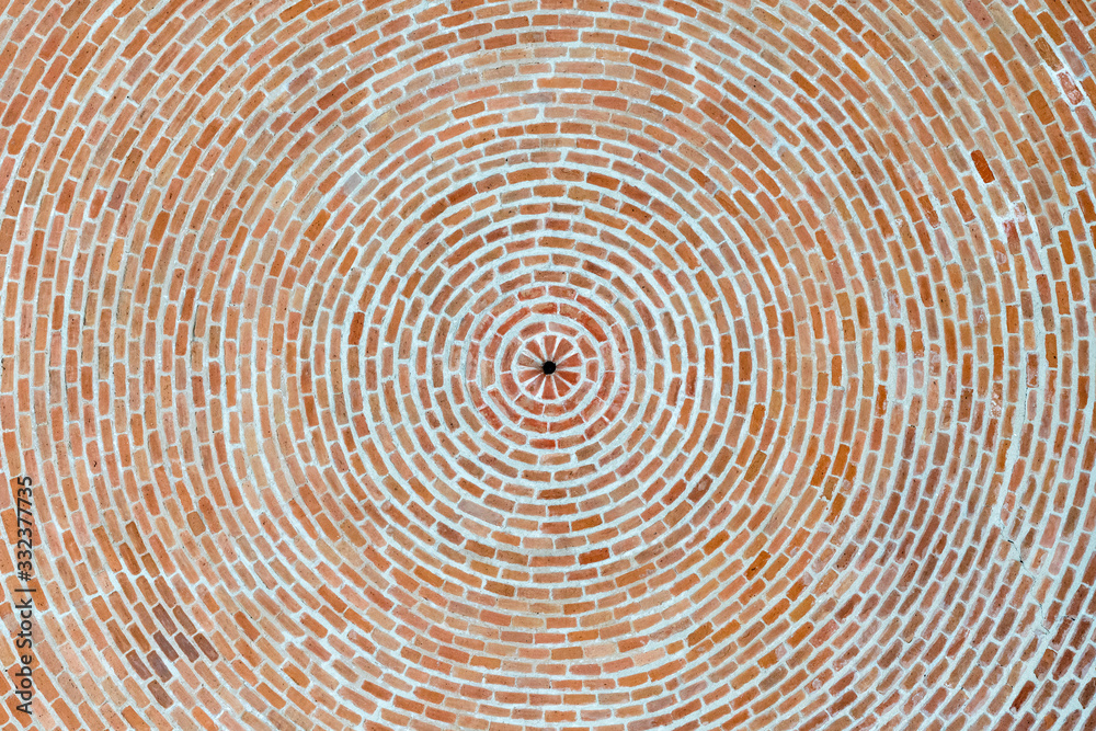Fototapeta premium Beautiful bottom up view to the brick ceiling and antique chandelier. Texture of red brickwork. Rough surface. For background and design.