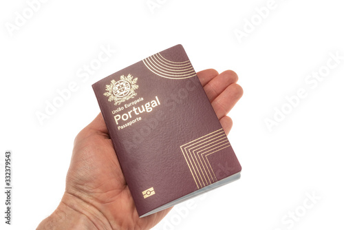 Portuguese travel passport in hand closeup. On white background.