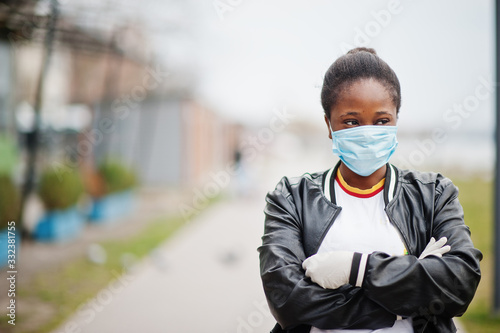 African girl at park wearing medical masks protect from infections and diseases coronavirus virus quarantine.