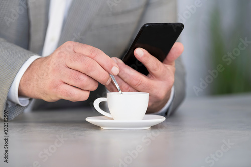 Man checking the phone on a coffee break