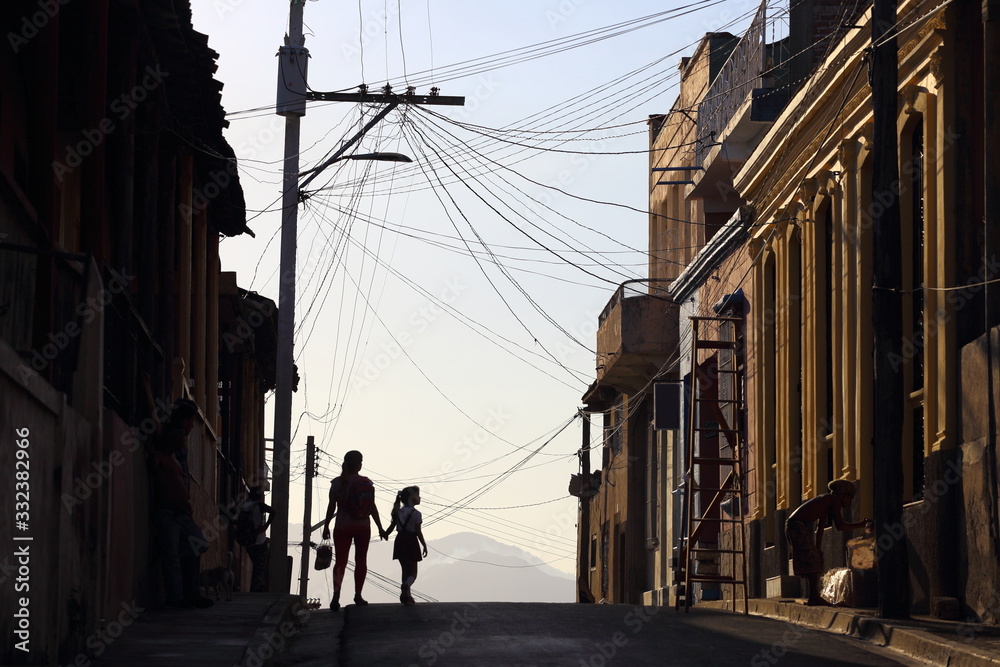 Silhouettes of people on the street of Santiago de Cuba, Cuba
