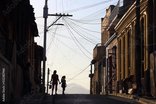 Obraz na płótnie Silhouettes of people on the street of Santiago de Cuba, Cuba w salonie