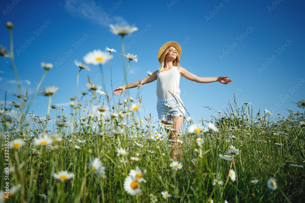 Woman in a field with flowers. A young and beautiful girl is resting in a chamomile field. Woman in a field with flowers. A young and beautiful girl is resting in a chamomile field.