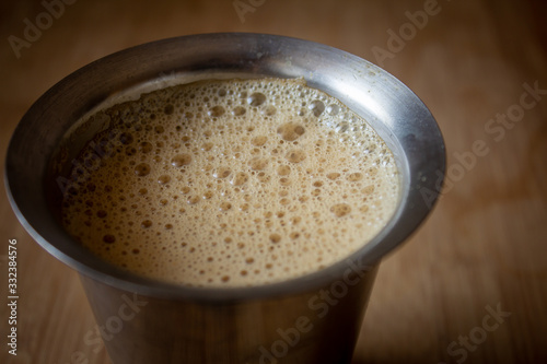 View of filter coffee in a stainless steel tumbler. Chennai is famous for authentic filter coffee. photo