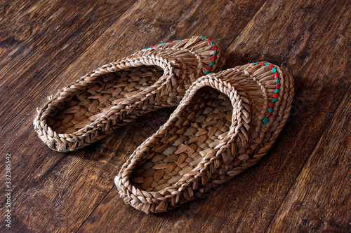 Wicker home low slippers, bast shoes or Lapti woven from wood bast. A modern version of old traditions.