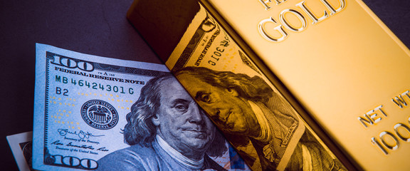 A bar of gold and a hundred-dollar bills.