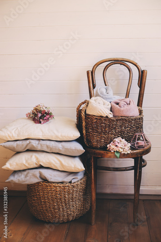 cozy interior details, scandinavian lifestyle. Organizing clothes in wicker backets, seasonal wardrobe and house cleaning, ideas for winter season. photo