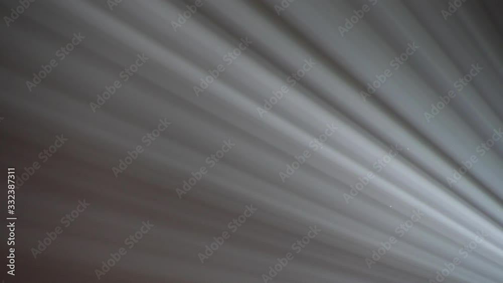 Close up scene on ray of light isolated on black background, line pattern of beam form spotlight, sunlight shine through hole of slit with dust fog in dark room, decorative element for graphic design Close up scene on ray of light isolated on black background, line pattern of beam form spotlight, sunlight shine through hole of slit with dust fog in dark room, decorative element for graphic design