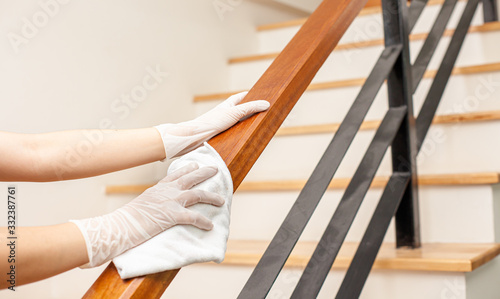 Deep cleaning for Covid-19 disease prevention. alcohol,disinfectant spray on Wipes of Banister in home for safety,infection of Covid-19 virus,contamination,germs,bacteria that are frequently touched .