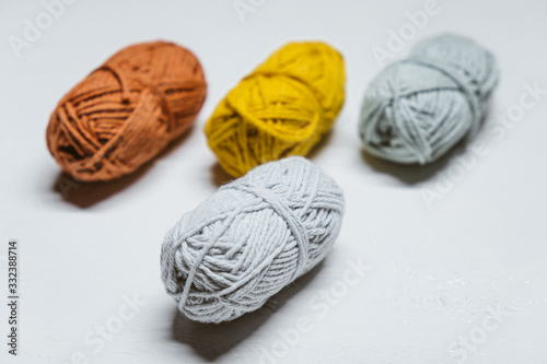 Colorful small wool yarns on white background isolated.