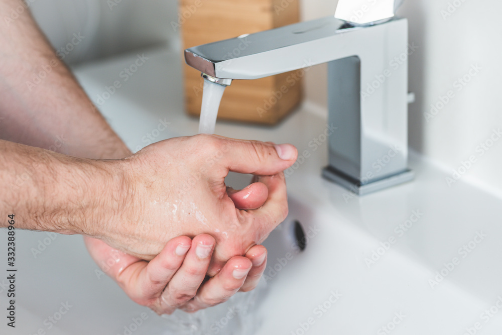 Hand washing with soap in bathroom to prevent contamination, close up Hand washing with soap in bathroom to prevent contamination, close up