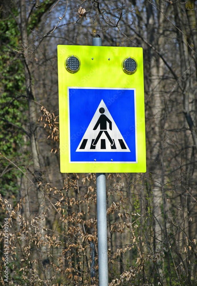Pedestrian crossing sign on the street Pedestrian crossing sign on the street
