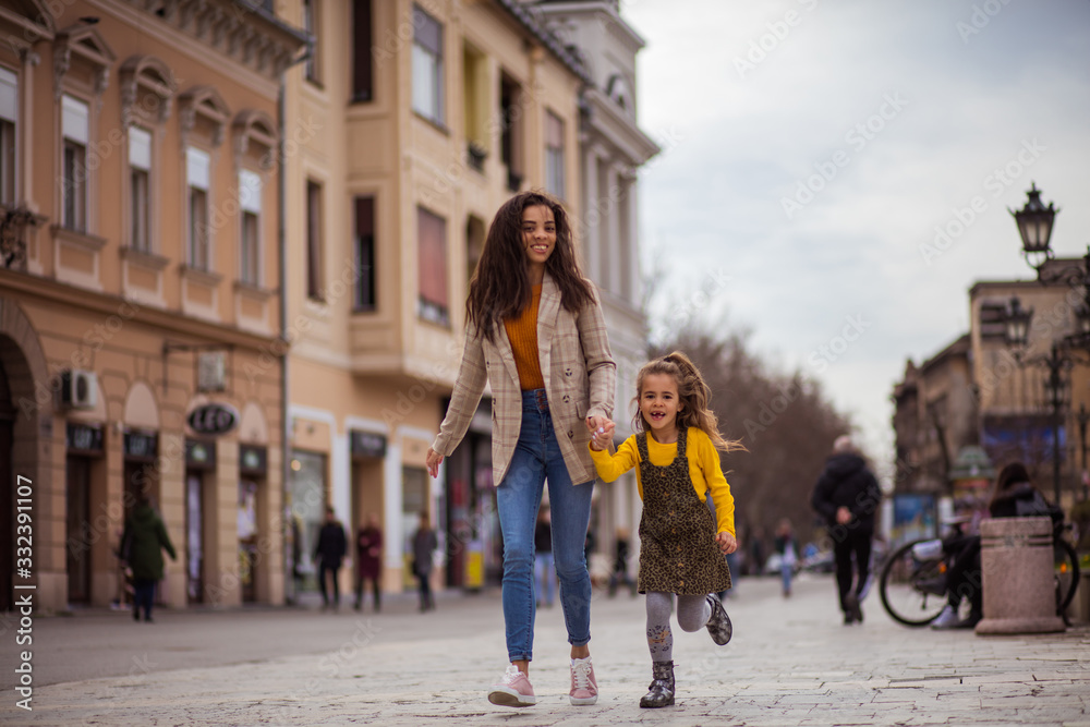 African American mother with her daughter at the city.