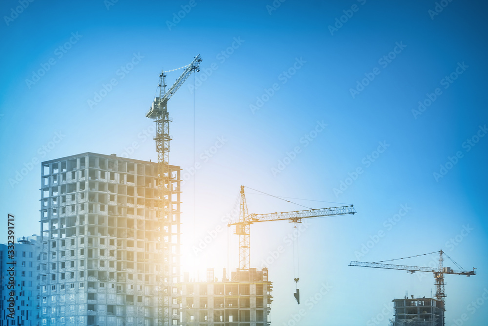 Construction site with cranes on sky background