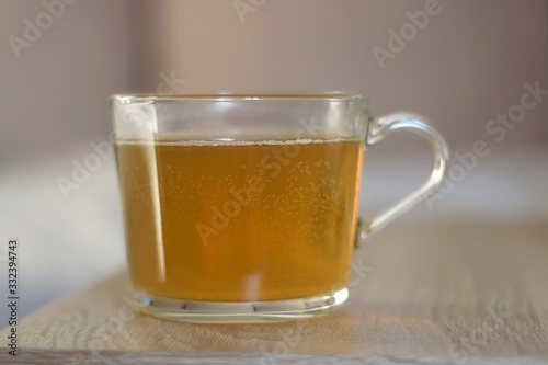 Cup of herbal tea on a living room table. Selective focus.