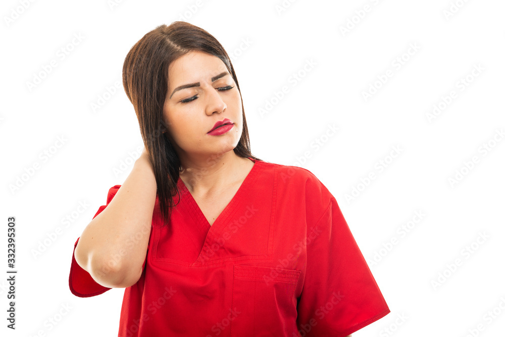 Portrait of doctor wearing scrubs holding back head like hurting Portrait of doctor wearing scrubs holding back head like hurting