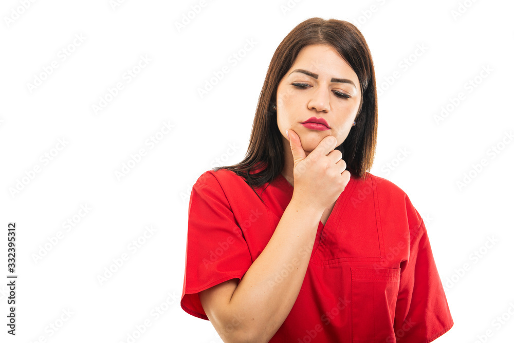 Portrait of beautiful young doctor wearing scrubs making thinking gesture Portrait of beautiful young doctor wearing scrubs making thinking gesture