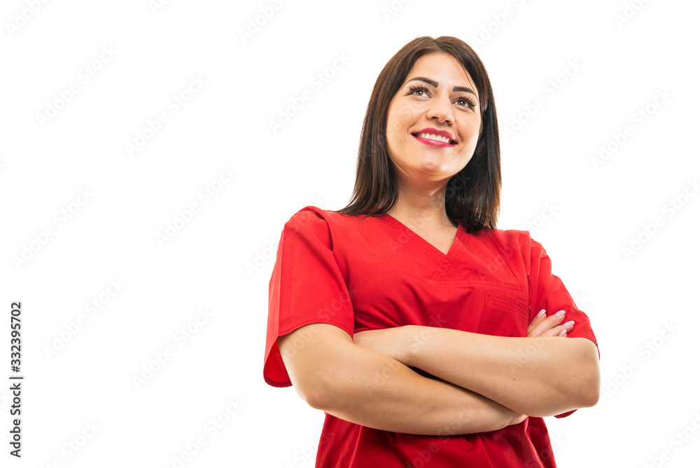 Low angle of doctor wearing scrubs standing with arms crossed Low angle of doctor wearing scrubs standing with arms crossed