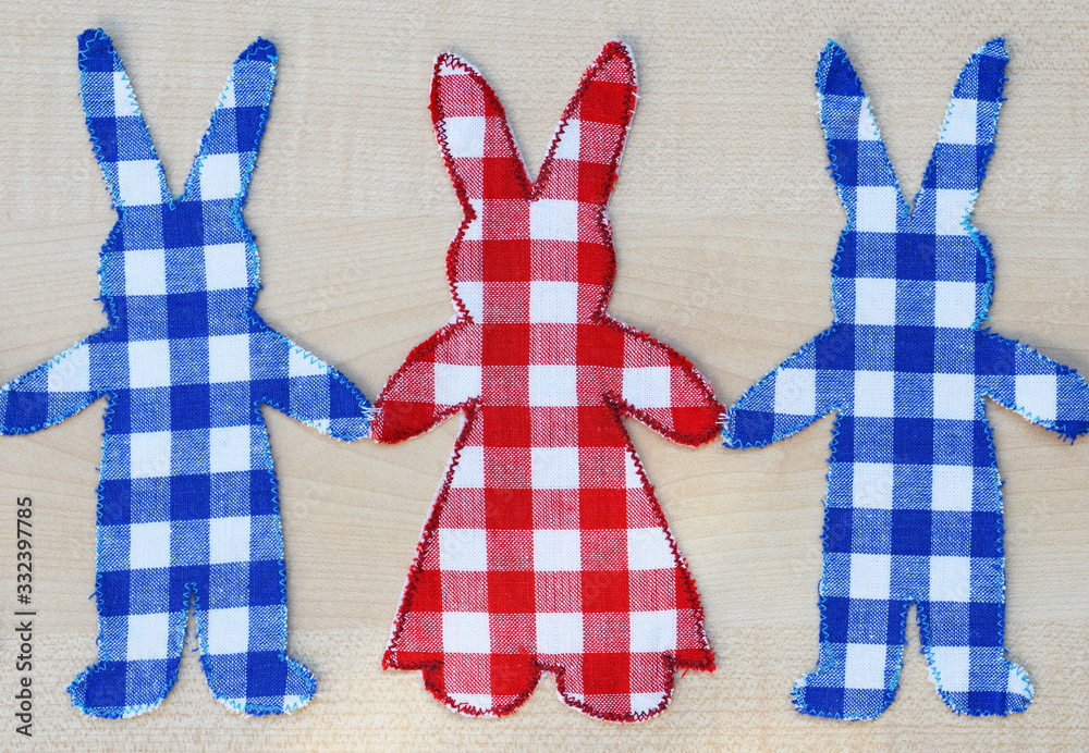 Obraz premium Homemade fabric bunnies holding hands - creative hobby in spring or Easter time