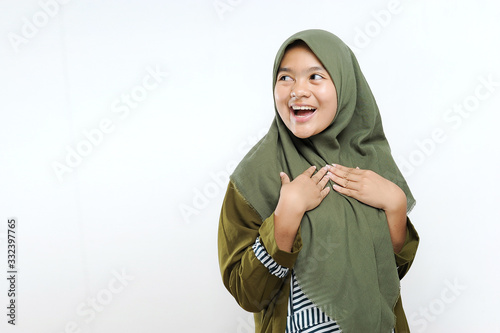 Happy smiling young Muslim women look at copy space. Portrait of excited young Musim women presenting something