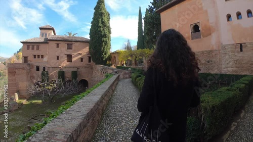 Tourist walking through the monumental complex of the Alhambra. Granada, Andalusia, Spain.
