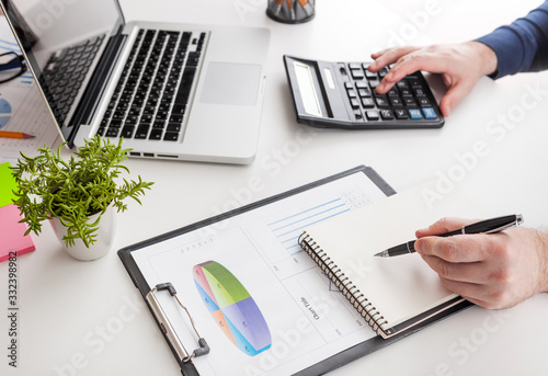 stock market chart and finger pointing on tablet in office