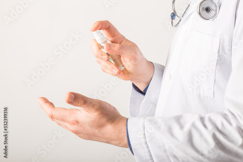 Doctor hands using washing hand with Alcohol Sanitizer  on a white background. Protect themselves from virus infection in Corona virus crisis 2020