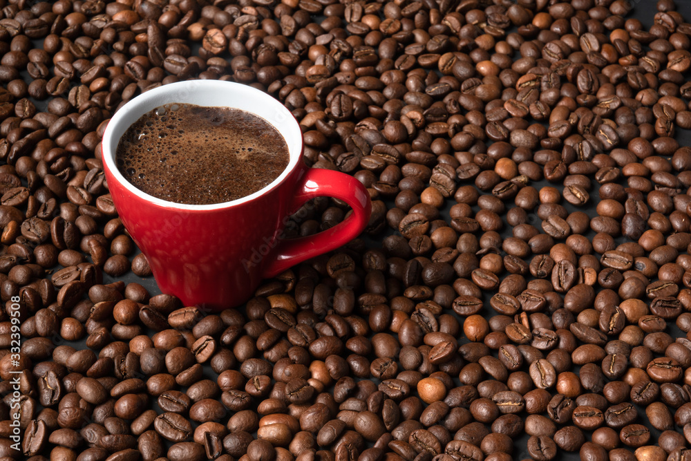 coffee in a red cup on a background of coffee beans coffee in a red cup on a background of coffee beans