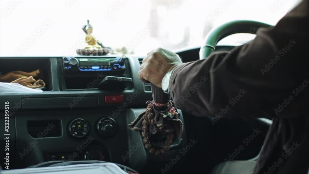 A close view on taxi drivers hands in East Asia Nepal, Kathmandu. Buddhist statue. A close view on taxi drivers hands in East Asia Nepal, Kathmandu. Buddhist statue.