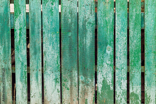 Old wooden fence painted green. Wallpaper or background