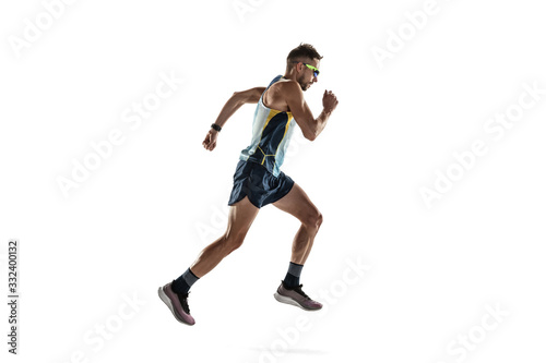 Triathlon male athlete running isolated on white studio background. Caucasian fit jogger, triathlete training wearing sports equipment. Concept of healthy lifestyle, sport, action, motion. Side view. © master1305